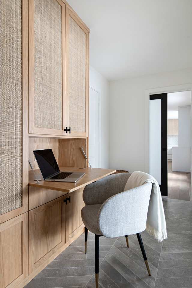 dual purpose desk set up tucked in wicker wooden cabinet in entryway of designer home